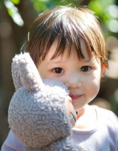 child holding a labubu toy